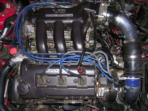 1996 Ford Probe - The engine features a V6 DOHC 24-valve configuration with prominent blue spark plug wires and intake piping.