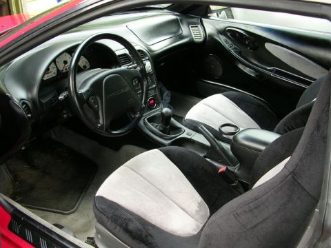 1996 Ford Probe - The interior of a 1996 Ford Probe features two-tone seats and a manual transmission shifter.