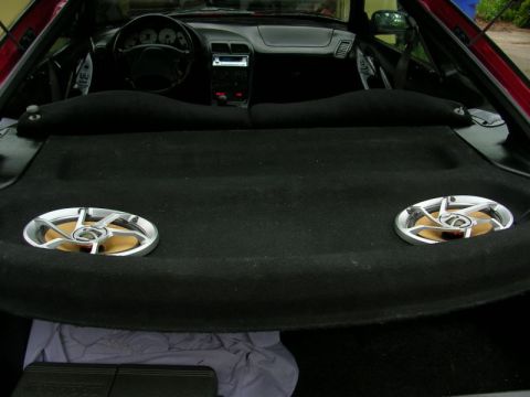 1996 Ford Probe - The interior of a 1996 Ford Probe is visible, including the dashboard, steering wheel, and aftermarket rear speakers.