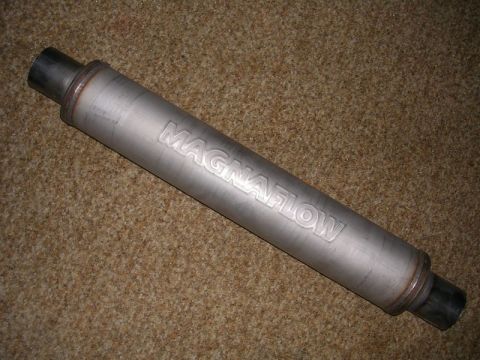 1996 Ford Probe - A Magnaflow exhaust muffler is shown against a textured background, with its brand name clearly visible.