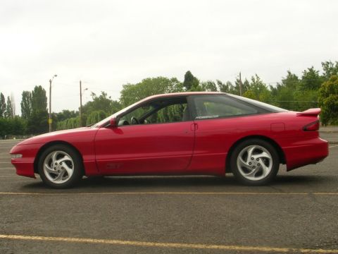 1996 Ford Probe - Side profile of a red 1996 Ford Probe GT parked outdoors.