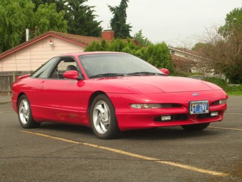 1996 Ford Probe - 1996 Ford Probe GT in red, seen from the front-right angle in a parking lot.