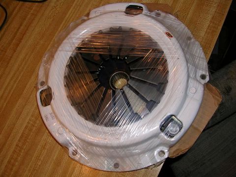 1996 Ford Probe - A clutch pressure plate is shown, wrapped in plastic, with a visible part number.