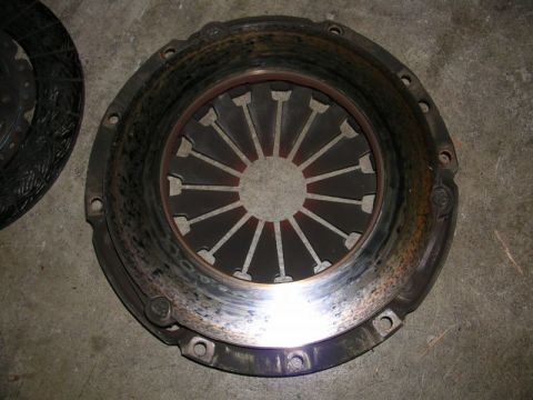 1996 Ford Probe - A used clutch pressure plate and disc are shown on a concrete surface.