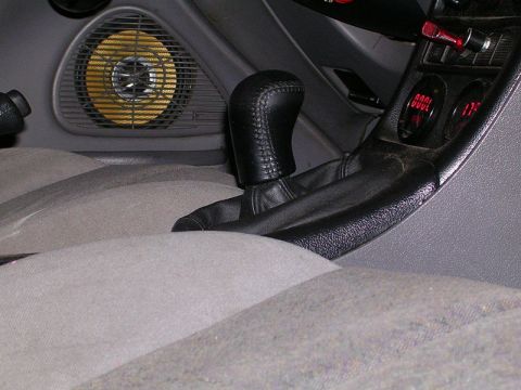1996 Ford Probe - Aftermarket gauges and speaker installed in a car's interior.