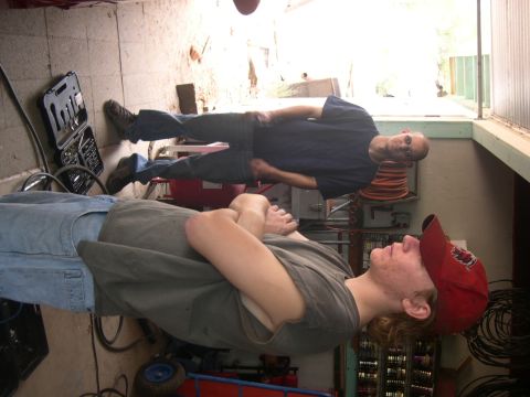 1997 Ford Probe - Two men are in a garage with tools and equipment around them.