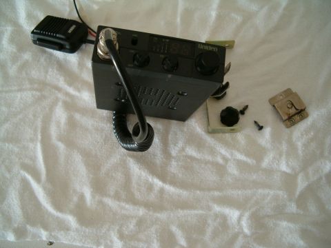 1991 Ford Bronco - A Uniden CB radio and its microphone are shown with some mounting hardware and screws.