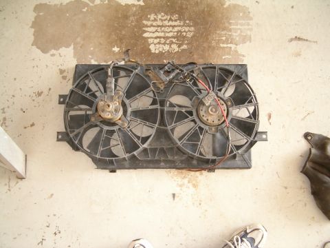 1991 Ford Bronco - This radiator fan assembly features dual fans and visible wiring, likely for a vehicle's cooling system.