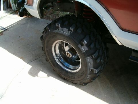 1991 Ford Bronco - A 1991 Ford Bronco is shown with its large off-road tires and chrome rims.