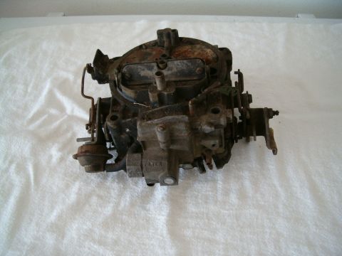 1991 Ford Bronco - This is a used carburetor, showing signs of wear and rust. The word 'FILTER' is visible on its casing.