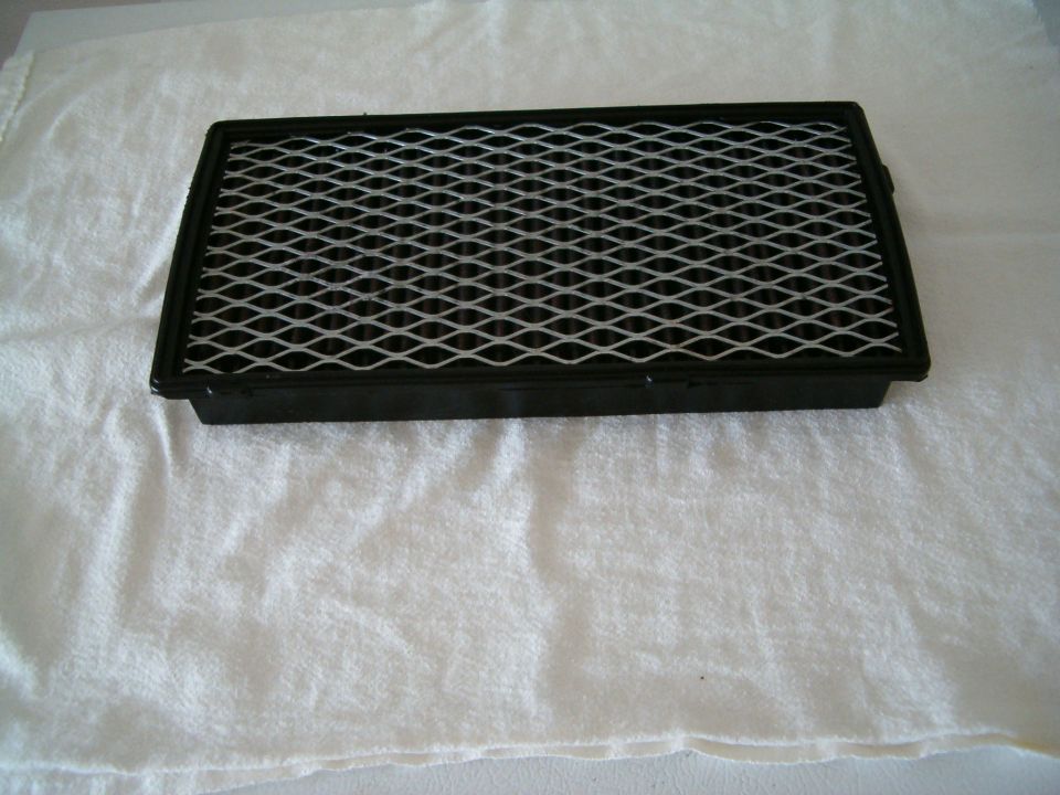 Rectangular air filter with black frame and white mesh grid