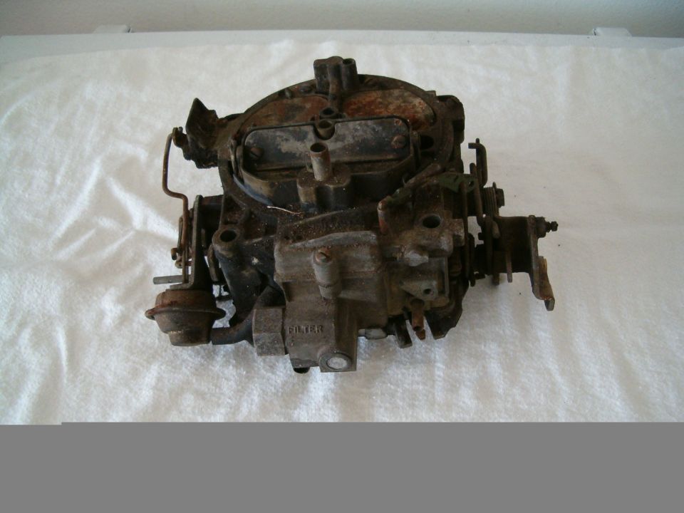 Used carburetor with visible rust and dirt, labeled "FILTER"