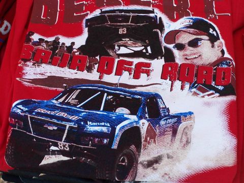 1979 Ford Bronco - Graphic t-shirt depicts off-road racing with two trucks and a driver.