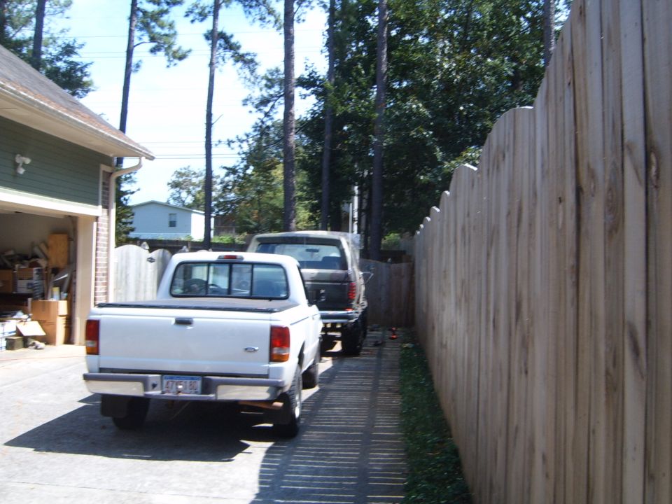 1997 Ford Ranger pickup truck parked in driveway next to another truck