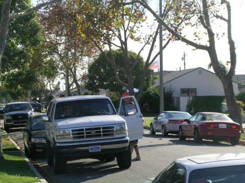 1993 Ford Probe - A silver 1992 Ford F-Series truck is parked on the street with its driver's door open, while other vehicles are visible in the background.