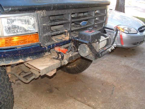1993 Ford Bronco - The front of a 1993 Ford Bronco features a winch mounted to the bumper, along with tow hooks.