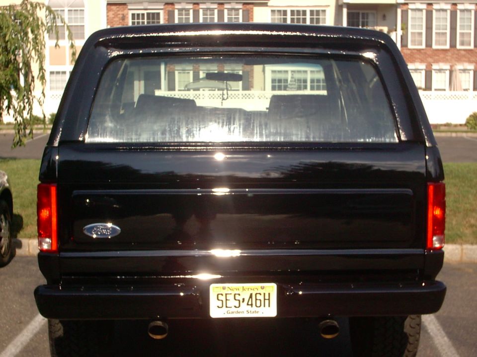 Rear view of a black Ford Bronco with a New Jersey license plate SES-46H