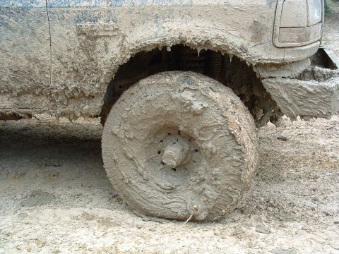 1993 Ford Bronco - This vehicle is heavily covered in mud, obscuring its make and model details.