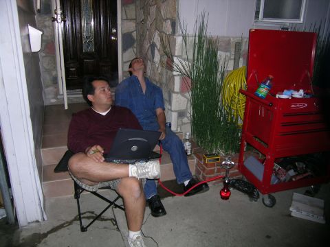 1993 Ford Probe - Two men relax on a porch with a laptop and a hookah, a red toolbox nearby.