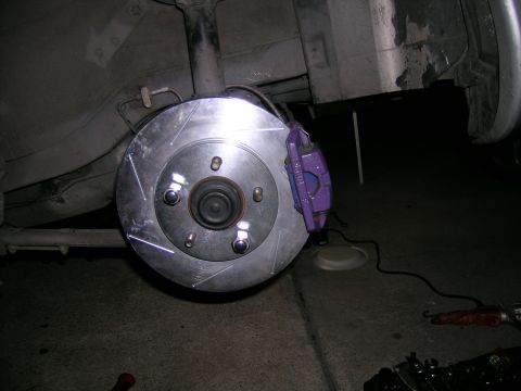 1993 Ford Probe - Close-up of a purple brake caliper and slotted rotor, likely a performance upgrade.