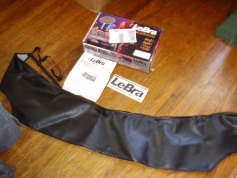 1997 Ford Taurus - LeBra car bra and its packaging are laid out on a wooden floor.