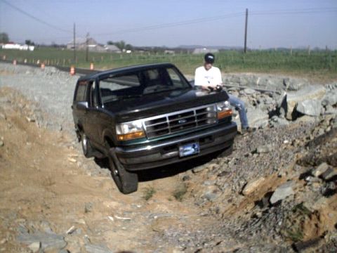 1996 Ford Bronco - A black 1996 Ford Bronco navigates a challenging rocky path.