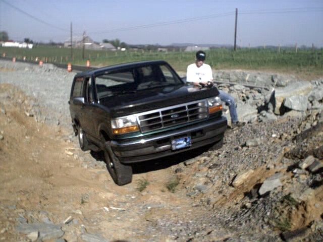 Black 1996 Ford Bronco on rocky terrain