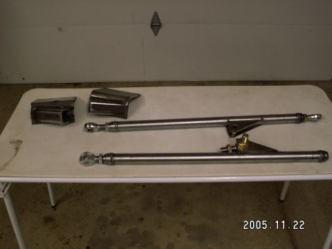 1991 Ford Explorer - Custom suspension links and brackets laid out on a table, likely for a vehicle modification project.