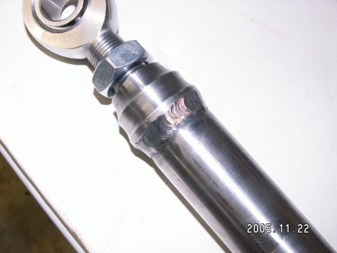 1991 Ford Explorer - Close-up of a metal rod with a spherical joint and adjustment nut, visible welds.
