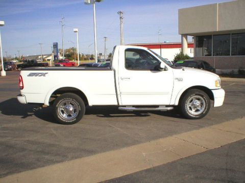 2003 Ford F-150 - Side view of a white 2003 Ford F-150 STX pickup truck parked in a lot.