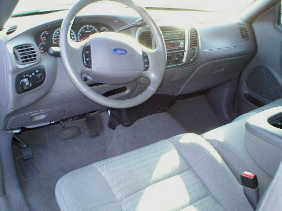2003 Ford F-150 interior showing dashboard, steering wheel, and passenger seat