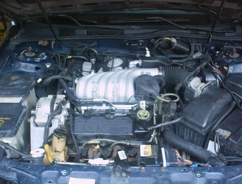 1993 Ford Taurus - The engine bay of a vehicle, showing the V6 engine and associated components.