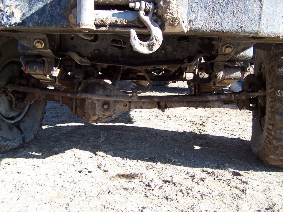 Undercarriage view of a 4x4 with a winch hook and leaf springs