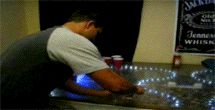 1993 Ford C-350 (Centurion Conversions) - Man arranges beer pong setup with lights, Jack Daniels sign visible.