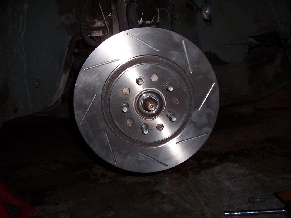 Slotted brake rotor installed on a vehicle hub