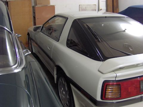 1994 Ford Probe - The rear quarter panel and taillight of a white coupe are visible.