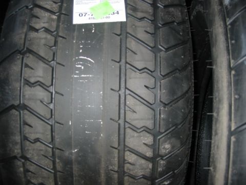 1985 Ford LTD Crown Victoria - A close-up view of two vehicle tires, showing their tread patterns and sidewalls.