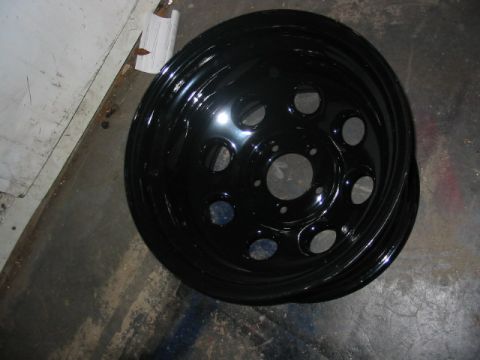 1985 Ford LTD Crown Victoria - A black steel wheel with a five-lug pattern is shown, likely a replacement part.