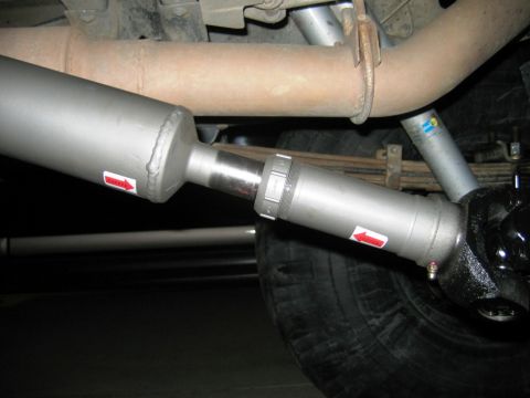 1985 Ford Bronco - Undercarriage view of a vehicle's driveshaft and suspension components.