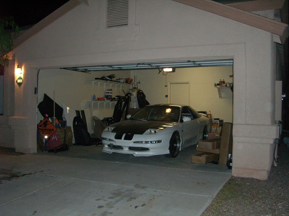 White 1996 Ford Probe with black hood stripes, front 3/4 view