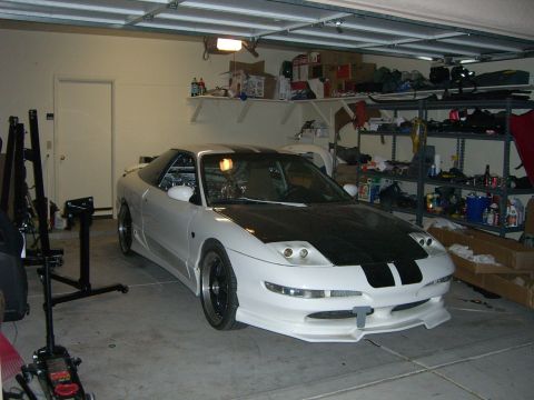 1996 Ford Probe - A modified white coupe with a black hood sits in a cluttered garage.