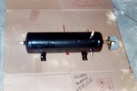 1994 Ford Bronco - A black air tank with brass fittings and a gray end cap rests on a cardboard surface. Handwritten text on the cardboard reads 'LYNCH MASTER…