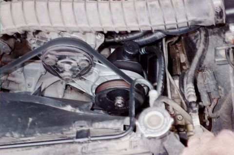 1994 Ford Bronco - Close-up view of the engine compartment in a 1994 Ford Bronco, highlighting the power steering pump and associated components.