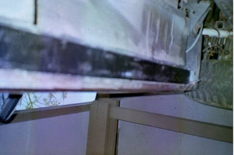 1994 Ford Bronco - Close-up view of a vehicle's rocker panel and tire, showing the underside.