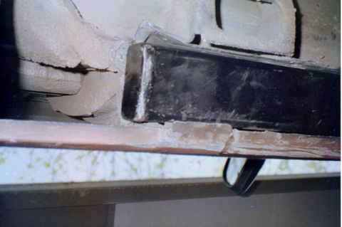 1994 Ford Bronco - Undercarriage detail showing a black bumper or trim piece with visible corrosion and damage.