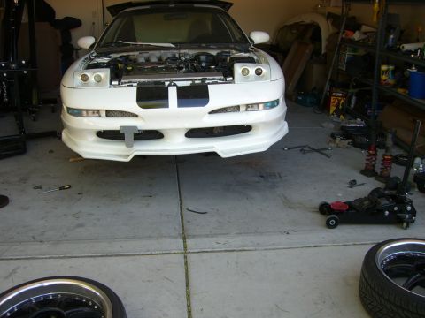 1996 Ford Probe - A white 1996 Ford Probe is parked in a garage with its hood open, revealing the engine compartment.