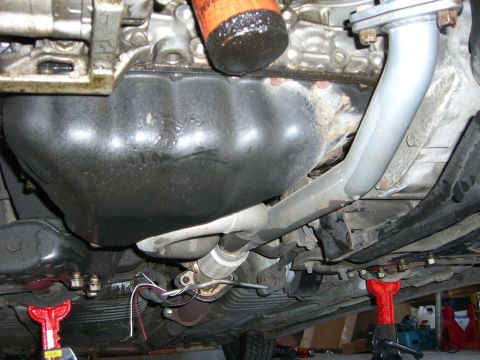 1996 Ford Probe - The underside of a vehicle's engine compartment, including the oil pan and exhaust system, is visible.