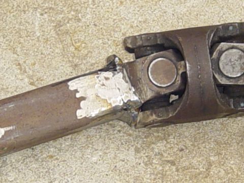 1989 Ford Bronco - This image shows a close-up view of a driveshaft U-joint, a critical component in vehicle power transmission.