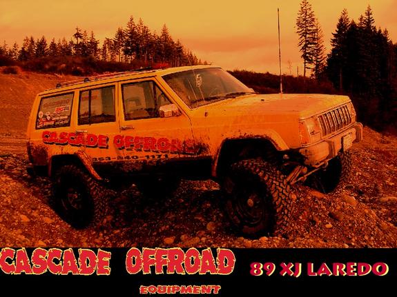 Heavily color-graded photo of muddy lifted yellow Jeep Cherokee on a trail with text overlays