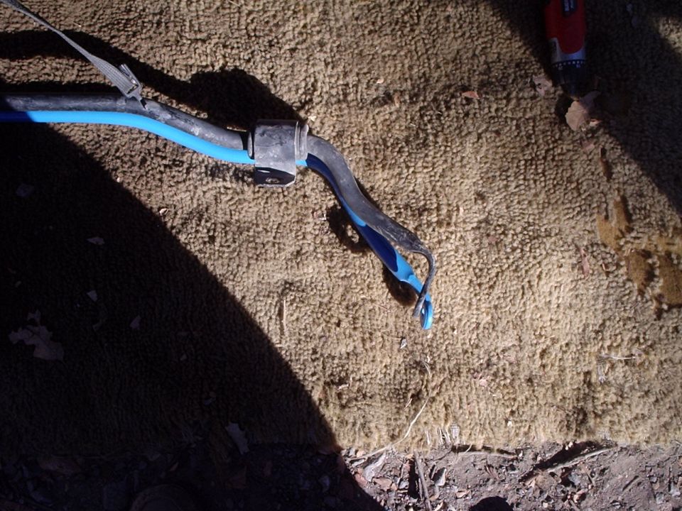 Close-up of a car's suspension part with blue and black components